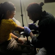 Best-Tattoo-Studio-in-Kerala Tattoo artist working on a client at the best tattoo studio in kerala